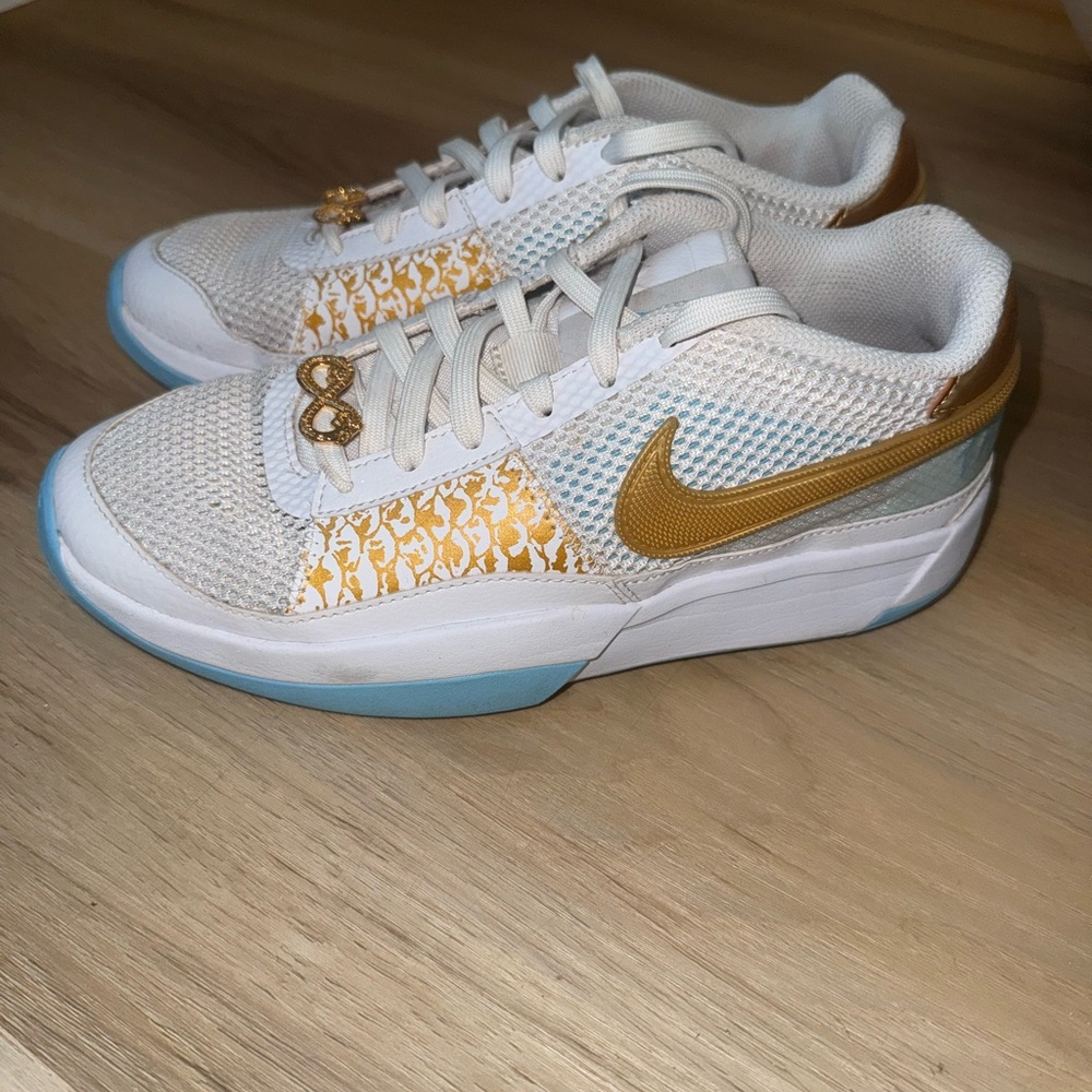 Nike White and Gold Athletic Shoes with Blue Soles